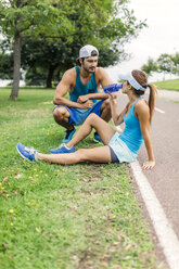 Young couple working out, taking a break - MGOF000633