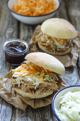 Homemade pulled pork with carrot and cabbage salad on hamburger bun - ODF001249