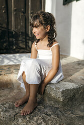 Spain, Balearic Islands, Menorca, Binibeca, portrait of little girl sitting on a step - MGOF000653