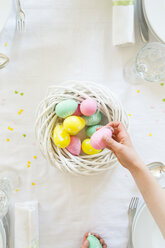 Little girl decorating dining table with Easter eggs - LVF003781