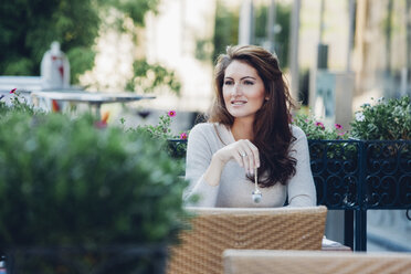 Smiling woman at outdoor cafe - CHAF001432