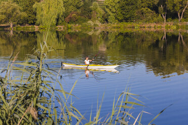 Germany, Stuttgart, woman kayaking on Max-Eyth-See - WDF003242