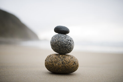 Spain, three rocks balanced on the beach - RAEF000450