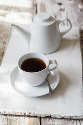 Cup of black coffee and coffee pot on wood - EVGF002167