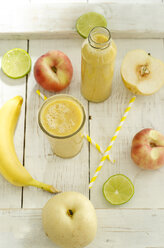 Fruits, glass bottle and glass of fruit smoothie on wood - ODF001261