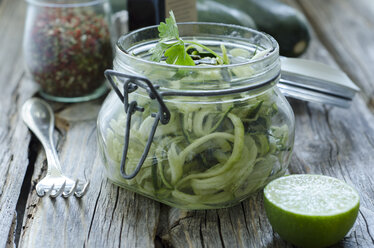 Preserving jar of sliced courgettes with lime and spices - ODF001273