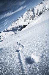 Austria, Tyrol, Ischgl, winter landscape in the mountains with tracks in snow - ABF000660