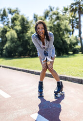 Spain, Gijon, happy teenage girl on roller skates - MGOF000984
