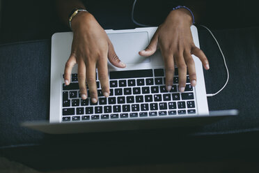 Woman's hand typing on keyboard of laptop - EBSF000885