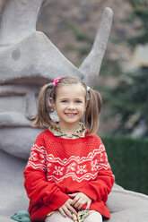 Portrait of a smiling little girl with braids wearing red-white knit pullover - XCF000011