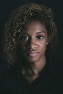 Porträt einer attraktiven jungen Frau vor einem schwarzen Hintergrund - EBSF000903