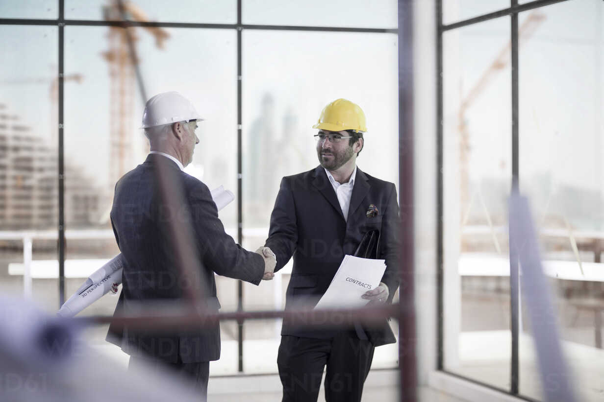 Two men with hard hats at construction site stock photo