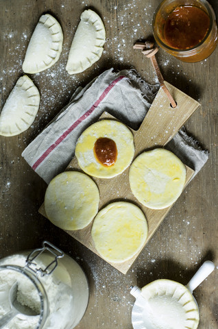 Preparing stuffed pastry of yeast dough and tomato pesto stock photo