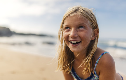 Portrait of smiling blond girl on the beach stock photo