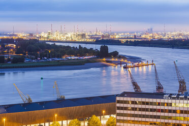 Belgium, Flanders, Antwerp, View to dock area with industrial area at Scheidt river in the evening - WDF003279