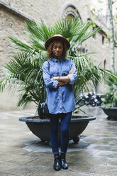 Spain, Barcelona, portrait of young woman wearing hat and denim shirt - EBSF000931