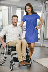 Man in wheelchair with his girlfriend, smiling happily - MFF002226