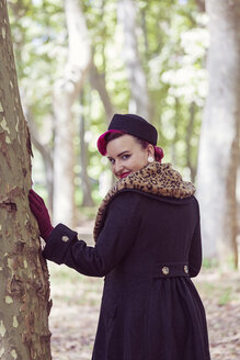 Portrait of fashionable young woman with coloured hair viewing over her shoulder in the woods - XCF000024