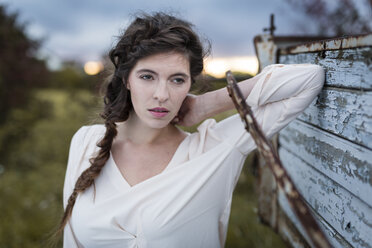 Portrait of woman with braid at twilight - SHKF000371