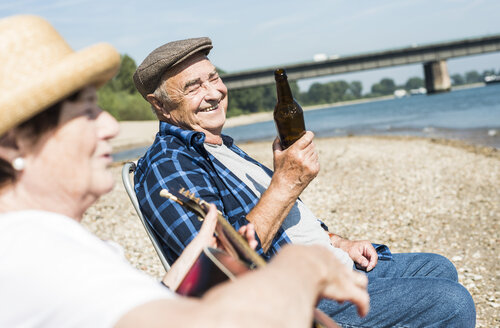 Germany, Ludwigshafen, portrait of senior man having fun at riverside - UUF005701