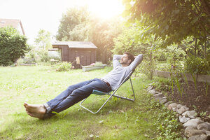 Man relaxing in garden chair - RBF003167