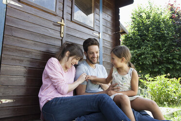 Happy family with daughter at garden shed - RBF003236