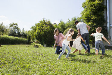 Playful family of five in garden - RBF003244