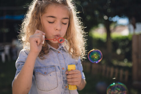 Little girl blowing soap bubbles - RAEF000500