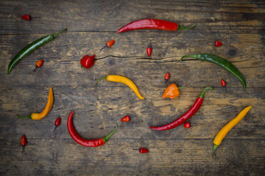 Different chili peppers on wood - LVF003883