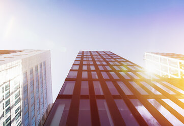 Bright sunshine reflecting in glass facades of modern office buildings - ZMF000430