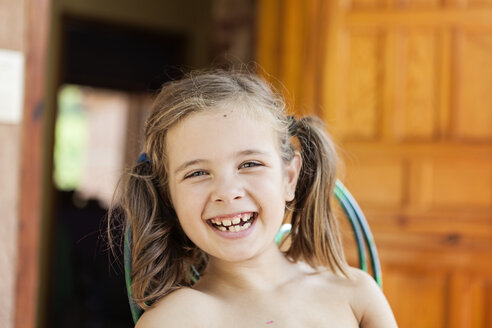 Portrait of happy little girl with braids and tooth gaps - XCF000038