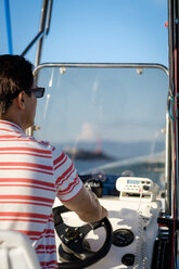 Mexico, Puerto Vallarta, man steering a boat - ABAF001929