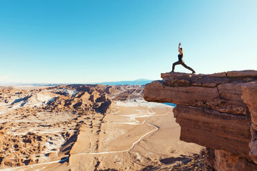 Chile, Atacama Desert, woman standing in yoga pose on a cliff - GEMF000396