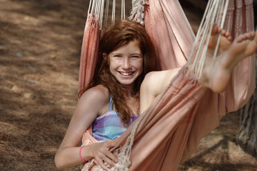 Portrait of smiling girl lying in a hammock - LBF001218