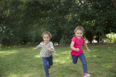Two girls running in a park - ERLF000036