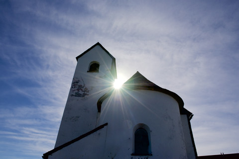 Austria, Tyrol, Kitzbuehel, Pilgrimage church Hohe Salve against the sun light stock photo