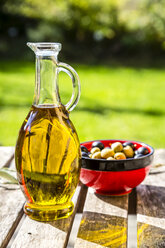 Bowl with green and black olives and carafe of olive oil - SARF002155