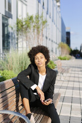 USA, New York City, businesswoman relaxing on a bench - GIOF000187