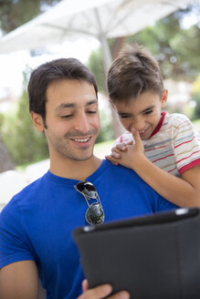 Portrait of father and son with digital tablet - ERLF000047