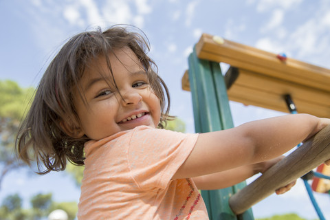 Portrait of smiling little girl on a playground stock photo