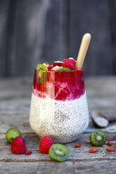 Glass of chia pudding with cocos, raspberry sauce and several fruits - SARF002165