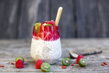 Glass of chia pudding with cocos, raspberry sauce and several fruits - SARF002171