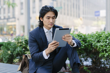 USA, New York City, Manhattan, businessman looking at digital tablet - GIOF000223