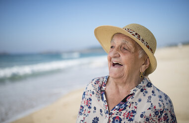 Spain, Ferrol, portrait of laughing senior woman on the beach - RAEF000530