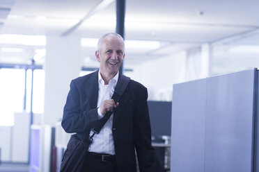 Smiling businessman in open space office - SGF001913