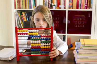 Girl using abacus at home - SARF002179