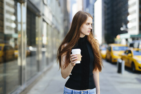 USA, New York City, portrait of young woman with coffee to go - GIOF000266