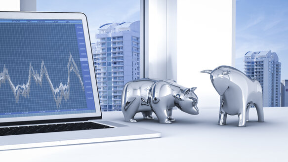 Bull and bear on desk with stock chart on laptop - AHUF000050