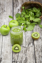 Glass of apple kiwi spinach smoothie and ingredients - LVF003962