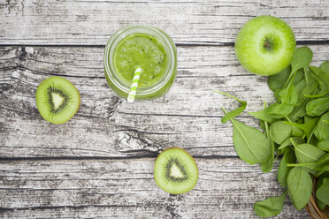 Glass of apple kiwi spinach smoothie and ingredients - LVF003963